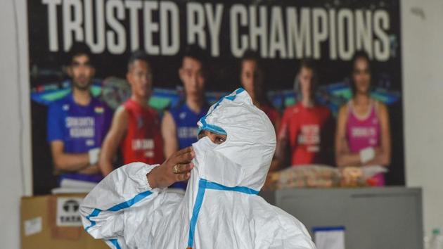 A health worker gears up in his PPE kit inside Common Wealth Games Village COVID-19 care Centre, in New Delhi on August 3. On August 5, 11 new deaths were reported in Delhi, taking the total number of fatalities due to COVID-19 to 4,044. This was the lowest number of daily deaths in Delhi over 70 days. (Manvender Vashist / PTI)