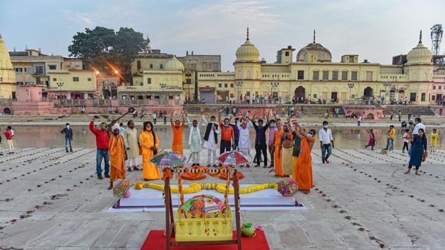Large wooden slippers, bow and arrow, and palanquin put on display at Naya Ghat, on the eve of the groundbreaking ceremony of the Ram Mandir, in Ayodhya, on Tuesday.(PTI Photo)