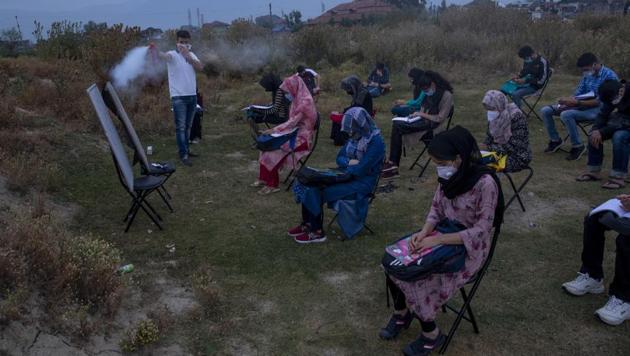 Muneer Alam, an engineer-turned-math teacher, sprays disinfectant before the start of an early morning outdoor class at Eidgah, a ground reserved for Eid prayers, in Srinagar, Indian controlled Kashmir, Friday, July 18, 2020. (AP) Muneer Alam, an engineer-turned-math teacher, sprays disinfectant before the start of an early morning outdoor class at Eidgah, a ground reserved for Eid prayers, in Srinagar, Indian controlled Kashmir, Friday, July 18, 2020. (AP)