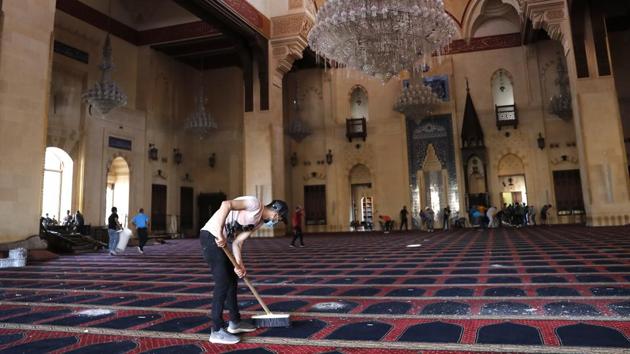 A man cleans a damaged mosque a day after an explosion hit the seaport of Beirut, Lebanon, Wednesday, Aug. 5, 2020.(AP photo)