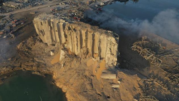 An aerial view of the destroyed silo sitting in rubble and debris after the explosion at Beirut seaport on August 5. Beirut’s major grain silo run by the Lebanese Ministry of Economy and Trade is estimated to store 85% of the country’s grain. Drone footage by the AP showed that the blast tore open those grain silos, dumping their contents into the debris and earth thrown up by the blast. (Hussein Malla / AP) An aerial view of the destroyed silo sitting in rubble and debris after the explosion at Beirut seaport on August 5. Beirut’s major grain silo run by the Lebanese Ministry of Economy and Trade is estimated to store 85% of the country’s grain. Drone footage by the AP showed that the blast tore open those grain silos, dumping their contents into the debris and earth thrown up by the blast. (Hussein Malla / AP)