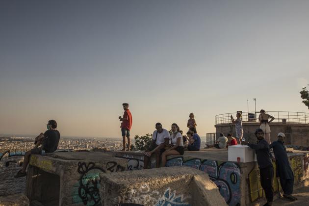 Visitors look over the city Barcelona from the Bunkers del Carmel viewpoint in Barcelona, Spain, on Saturday, Aug. 1, 2020. (Bloomberg)