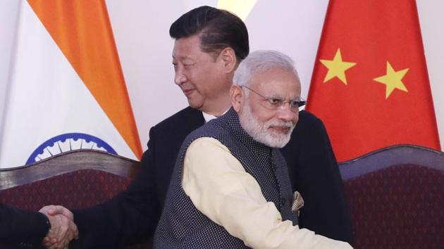 Prime Minister Narendra Modi and Chinese President Xi Jinping shake hands with leaders at the BRICS summit in Goa, India. (AP) Prime Minister Narendra Modi and Chinese President Xi Jinping shake hands with leaders at the BRICS summit in Goa, India. (AP)