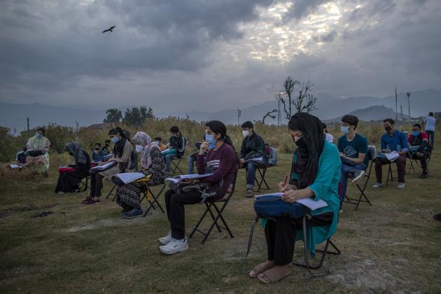 Kashmiri students attend an open-air early morning class inside Eidgah, a ground reserved for Eid prayers, in Srinagar, Jammu and Kashmir, Friday, July 18, 2020. (AP) Kashmiri students attend an open-air early morning class inside Eidgah, a ground reserved for Eid prayers, in Srinagar, Jammu and Kashmir, Friday, July 18, 2020. (AP)