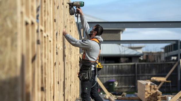 A builder works a on a construction site during lockdown due to the continuing spread of the coronavirus in Melbourne on August 6. Prime Minister Scott Morrison has warned the latest lockdown would cost the Australian economy -- facing its first recession in three decades -- up to US$9 billion and push the unemployment rate back to 13% after a slight recovery. (Andy Brownbill / AP) A builder works a on a construction site during lockdown due to the continuing spread of the coronavirus in Melbourne on August 6. Prime Minister Scott Morrison has warned the latest lockdown would cost the Australian economy -- facing its first recession in three decades -- up to US$9 billion and push the unemployment rate back to 13% after a slight recovery. (Andy Brownbill / AP)
