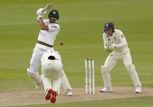Pakistan's Shan Masood plays a shot during the first day of the first cricket Test match between England and Pakistan at Old Trafford in Manchester, England, Wednesday, Aug. 5, 2020. (Lee Smith/Pool via AP) (AP)