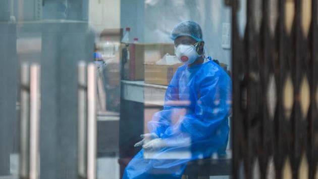 A health worker in PPE coveralls at a sample collection facility for coronavirus testing in Defence Colony, New Delhi. (Amal KS/HT Photo) A health worker in PPE coveralls at a sample collection facility for coronavirus testing in Defence Colony, New Delhi. (Amal KS/HT Photo)
