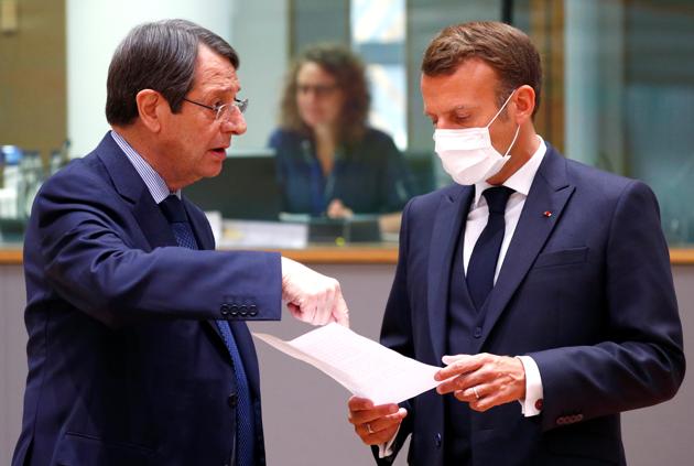 Cypriot President Nicos Anastasiades and France's President Emmanuel Macron speak during the first face-to-face EU summit since the coronavirus disease (Covid-19) outbreak, in Brussels, Belgium July 18, 2020.(Reuters photo)
