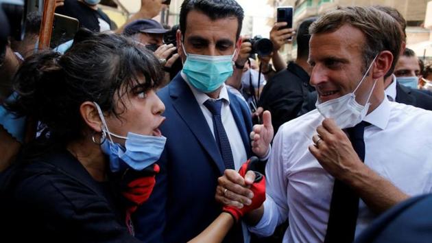 French President Emmanuel Macron listens to a resident as he visits a devastated street of Beirut, Lebanon August 6, 2020.(Reuters photo)