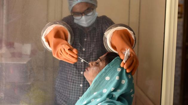 A health worker collects a swab sample from a woman for coronavirus test, at Urban Primary Health Center, in Gandhi Nagar, in Gurugram.(Parveen Kumar / Hindustan Times) A health worker collects a swab sample from a woman for coronavirus test, at Urban Primary Health Center, in Gandhi Nagar, in Gurugram.(Parveen Kumar / Hindustan Times)