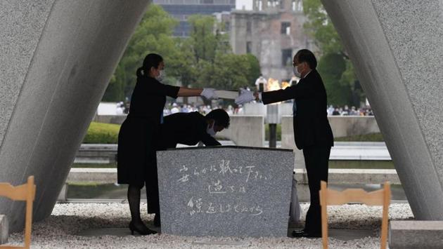 A representative of bereaved families of the 1945 atomic bombing victims, hands over a list of victims’ names to Hiroshima City mayor Kazumi Matsui at Peace Memorial Park in Hiroshima. “On August 6, 1945, a single atomic bomb destroyed our city. Rumour at the time had it that ‘Nothing will grow here for 75 years,’” Reuters quoted mayor Kazumi Matsui saying. “And yet, Hiroshima recovered, becoming a symbol of peace,” he added. (Kyodo via REUTERS)