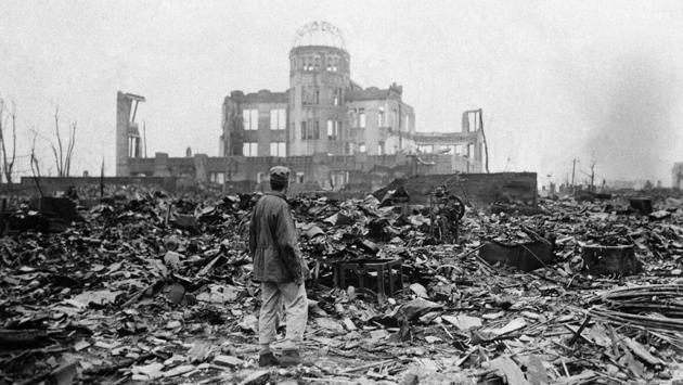 An allied correspondent stands in a sea of rubble before the shell of a building that once was a movie theatre in Hiroshima on September 8, 1945, a month after the first atomic bomb ever used in warfare was dropped by the US to hasten Japan’s surrender. Many people exposed to radiation developed symptoms such as vomiting and hair loss. Most of those with severe radiation symptoms died within three to six weeks. (Stanley Troutman / AP File)