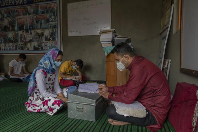 Iqra Nazir listens to her teacher Muneer Ahmed during a math coaching class in Srinagar, Jammu and Kashmir, Wednesday, July 22, 2020. Over the years, volunteer-run community schools and makeshift classrooms have emerged to fill the gap when formal schools shut down, but large-scale troop deployments and restrictions on public movement mean they reach only a small proportion of students. (AP) Iqra Nazir listens to her teacher Muneer Ahmed during a math coaching class in Srinagar, Jammu and Kashmir, Wednesday, July 22, 2020. Over the years, volunteer-run community schools and makeshift classrooms have emerged to fill the gap when formal schools shut down, but large-scale troop deployments and restrictions on public movement mean they reach only a small proportion of students. (AP)