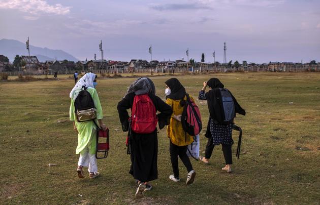 Kashmiri students walk homeward after attending an open-air class inside Eidgah, a ground reserved for Eid prayers, in Srinagar, Jammu and Kashmir, Friday, July 31, 2020. When months went by without teaching, Muneer Alam, an engineer-turned-math teacher, started the informal community school in the form of an open-air classroom in June. Schools in the region reopened after six months in late February, after a strict lockdown that began in August 2019. In March schools were shut again because of the coronavirus pandemic. (AP) Kashmiri students walk homeward after attending an open-air class inside Eidgah, a ground reserved for Eid prayers, in Srinagar, Jammu and Kashmir, Friday, July 31, 2020. When months went by without teaching, Muneer Alam, an engineer-turned-math teacher, started the informal community school in the form of an open-air classroom in June. Schools in the region reopened after six months in late February, after a strict lockdown that began in August 2019. In March schools were shut again because of the coronavirus pandemic. (AP)