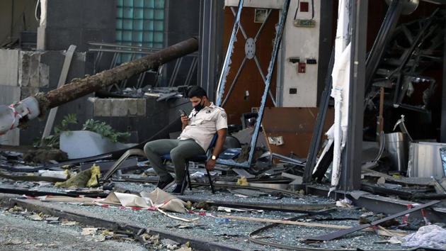 Security personnel sit in front of damaged buildings near the site of an explosion on Tuesday that hit the seaport of Beirut, Lebanon, Thursday, Aug. 6, 2020.(AP photo) Security personnel sit in front of damaged buildings near the site of an explosion on Tuesday that hit the seaport of Beirut, Lebanon, Thursday, Aug. 6, 2020.(AP photo)