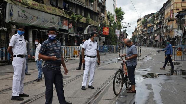 Police officers check travel permission papers of a man, during the two-day weekly lockdown in the West Bengal state, amidst the spread of the coronavirus disease (Covid-19), in Kolkata on August 5, 2020.(Reuters File Photo) Police officers check travel permission papers of a man, during the two-day weekly lockdown in the West Bengal state, amidst the spread of the coronavirus disease (Covid-19), in Kolkata on August 5, 2020.(Reuters File Photo)
