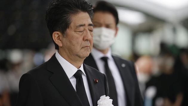 Japan’s Prime Minister Shinzo Abe offers a silent prayer for the victims of the 1945 atomic bombing, at Peace Memorial Park in Hiroshima on August 6. Hiroshima Mayor Matsui urged Japan to ratify a 2017 United Nations pact banning nuclear arms, but Abe avoided any direct reference, saying Japan would “work as a bridge between nations” to abolish nuclear weapons, Reuters reported. (Kyodo via REUTERS)