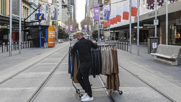 A department store employee wheels clothes across the Bourke Street Mall as retail businesses prepare to close their doors to walk-in customers on August 5. Australia has now recorded almost 20,000 COVID-19 cases and 255 fatalities, of which Victoria accounts for the bulk at just over 13,000. (Asanka Brendon Ratnayake / AP) A department store employee wheels clothes across the Bourke Street Mall as retail businesses prepare to close their doors to walk-in customers on August 5. Australia has now recorded almost 20,000 COVID-19 cases and 255 fatalities, of which Victoria accounts for the bulk at just over 13,000. (Asanka Brendon Ratnayake / AP)