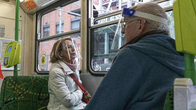 Two commuters wearing face shields are seen as they travel by tram during lockdown in Melbourne on August 5. Residents are still allowed to go out during the daytime for exercise and food, or for work if their business is deemed essential. (Asanka Brendon Ratnayake / AP) Two commuters wearing face shields are seen as they travel by tram during lockdown in Melbourne on August 5. Residents are still allowed to go out during the daytime for exercise and food, or for work if their business is deemed essential. (Asanka Brendon Ratnayake / AP)