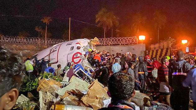 Rescue operations underway after an Air India Express flight with 190 passengers on board enroute from Dubai skidded off the runway while landing, at Karipur airport in Kozhikode on Friday.(PTI PHOTO.)