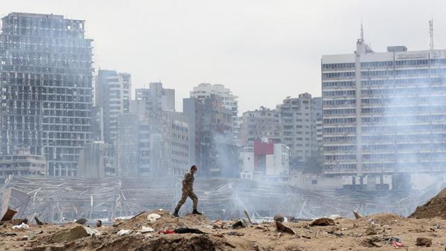 A Lebanese soldier walks at the site of the explosion in the port of Beirut on August 6. On August 4, a colossal explosion shook the city after a huge pile of ammonium nitrate that had languished for years in a port warehouse in Beirut caught fire. (Thibault Camus / AP)
