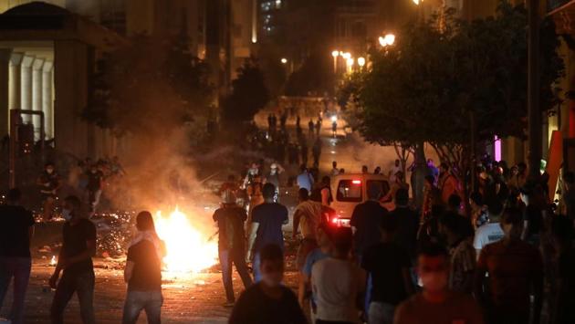 A gathering of demonstrators is seen near a fire during the protest in Beirut on August 7. Lebanese Prime Minister Hassan Diab and President Michel Aoun have promised to put the culprits responsible for the explosion behind bars, Reuters reported. (Mohamed Azakir / REUTERS)