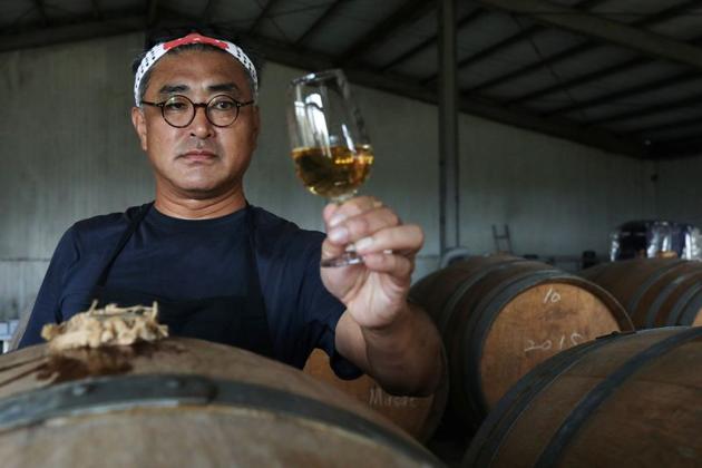 Chen Chien-hao, 52, holds a glass of his wine at Shu Sheng Leisure Domaine in Taichung, Taiwan, July 20, 2020. (REUTERS) Chen Chien-hao, 52, holds a glass of his wine at Shu Sheng Leisure Domaine in Taichung, Taiwan, July 20, 2020. (REUTERS)