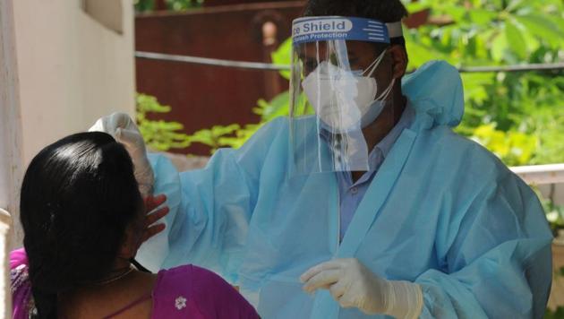 A health worker collects swab sample for Covid-19 testing at a health centre in Patna, Bihar, Aug 5, 2020.(AP Dube / HT Photo)