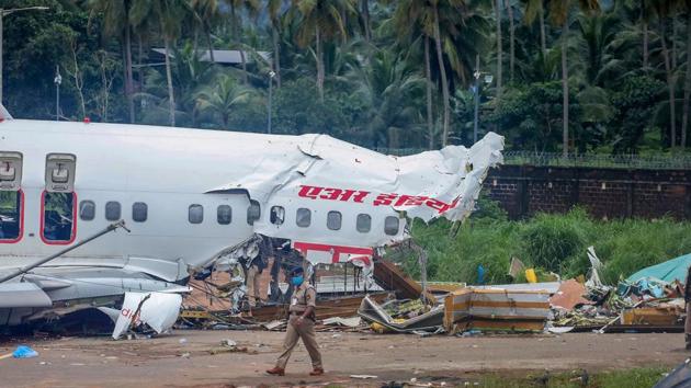 Mangled remains of an Air India Express flight, en route from Dubai, after it skidded off the runway while landing on Friday night, at Karippur in Kozhikode.(PTI)