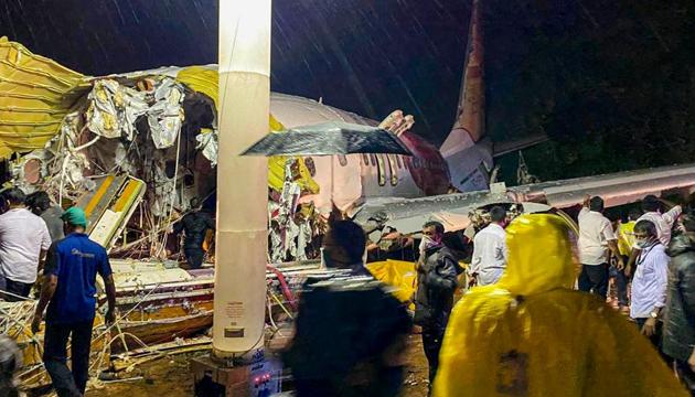 Kozhikode: Rescue operation underway after an Air India Express flight with passengers on board en route from Dubai skidded off the runway while landing at Karippur in Kozhikode, Kerala.(PTI)