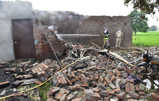 A fireman dousing flames after an explosion at a cracker factory in Ibban Kalan village near Amritsar on Saturday.(Sameer Sehgal/HT)