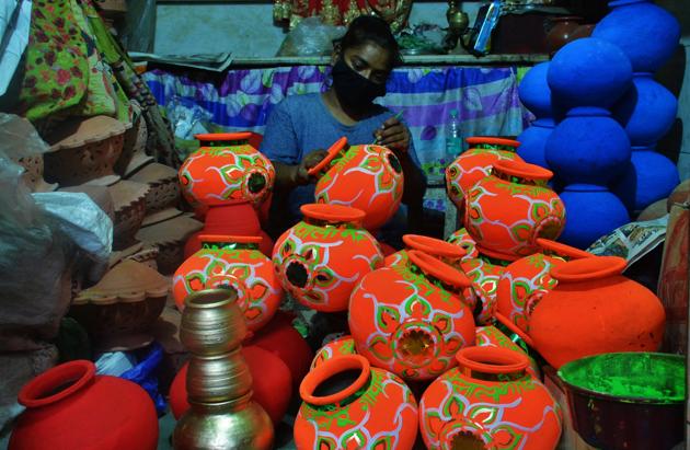 To celebrate the upcoming Krishna Janmashtami, a female artist is seen making a pot ( Mataki ) of Dahihandi in her workshop at Mahagiri area market in Thane, Mumbai, India, on Saturday, August 08, 2020. (Praful Gangurde/ HT Photo )