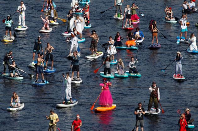 Participants dressed up as princesses, fictional characters, some wore ethnic outfits, while others were seen in protective gear as they made their way on the Fontanka river during the Fontanka-SUP stand up paddle boarding festival in Saint Petersburg, Russia August 8, 2020. (REUTERS)