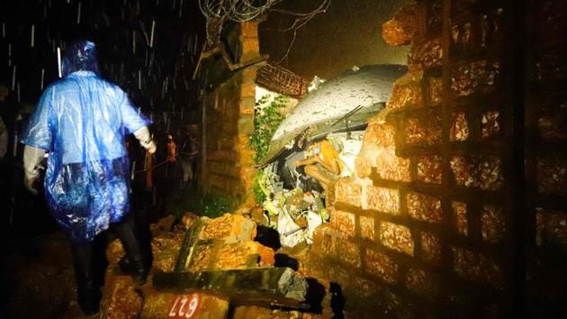 First responders inspect the wreckage of the Air India Express jet after it crashed by overshooting the runway at Calicut International Airport on August 7. The crash occurred around 7.40pm, when it was raining. The Boeing 737 jet, on a Vande Bharat mission as flight AIX 1344 from Dubai, was bringing in Indians who were stranded abroad due to the Covid-19 pandemic. (AFP) First responders inspect the wreckage of the Air India Express jet after it crashed by overshooting the runway at Calicut International Airport on August 7. The crash occurred around 7.40pm, when it was raining. The Boeing 737 jet, on a Vande Bharat mission as flight AIX 1344 from Dubai, was bringing in Indians who were stranded abroad due to the Covid-19 pandemic. (AFP)