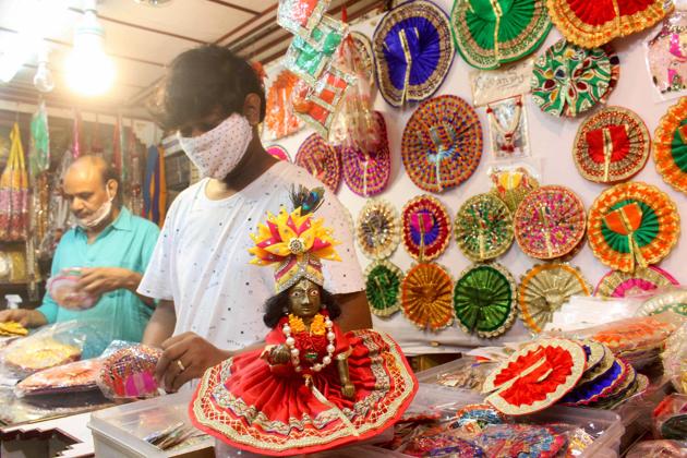 Shopkeepers selling Krishna idols and other decorative items wait for customers, ahead of Janmashtami festival, in Bhopal, Friday, Aug. 7, 2020. (PTI)