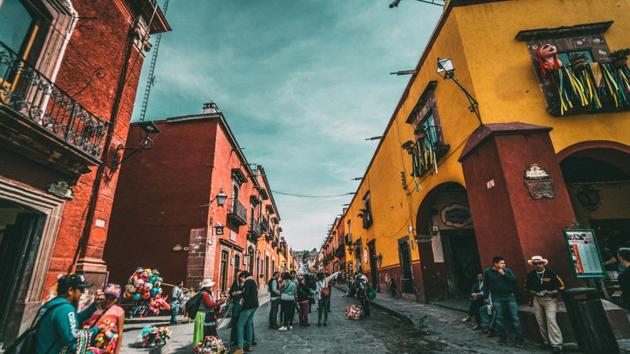 A colourful street in Mexico teeming with people. (Representational Image) (Unsplash) A colourful street in Mexico teeming with people. (Representational Image) (Unsplash)