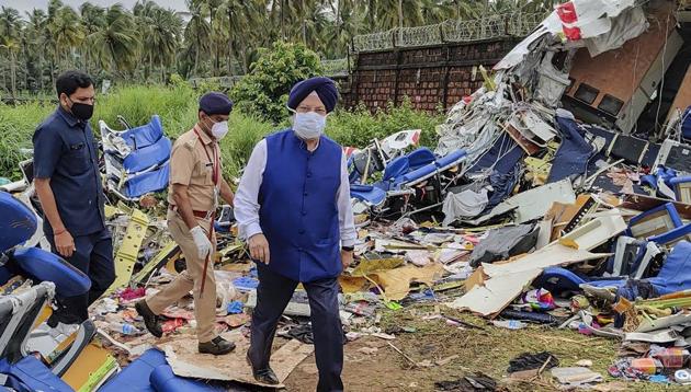 Union civil aviation minister Hardeep Singh Puri inspects the crash site of an Air India Express flight, en route from Dubai, after it skidded off the runway while landing, at Karippur in Kozhikode.(@HardeepSPuri/Twitter)