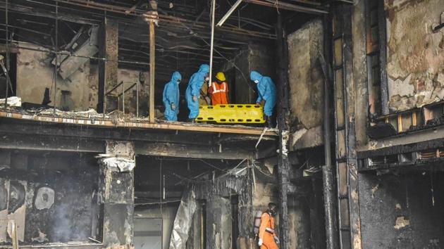 NDRF personnel wearing PPE kits carry out a rescue operation after a massive fire broke out at a hotel, turned into Covid-19 care centre, in Vijayawada, Sunday. Ten people have lost their lives and 30 have been rescued. (PTI Photo) NDRF personnel wearing PPE kits carry out a rescue operation after a massive fire broke out at a hotel, turned into Covid-19 care centre, in Vijayawada, Sunday. Ten people have lost their lives and 30 have been rescued. (PTI Photo)