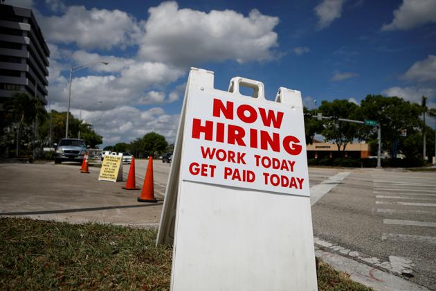 A "Now Hiring" sign advertising jobs at a hand car wash is seen along a street, as the spread of the coronavirus disease (Covid-19) continues, in Miami, Florida, US.(REUTERS) A "Now Hiring" sign advertising jobs at a hand car wash is seen along a street, as the spread of the coronavirus disease (Covid-19) continues, in Miami, Florida, US.(REUTERS)