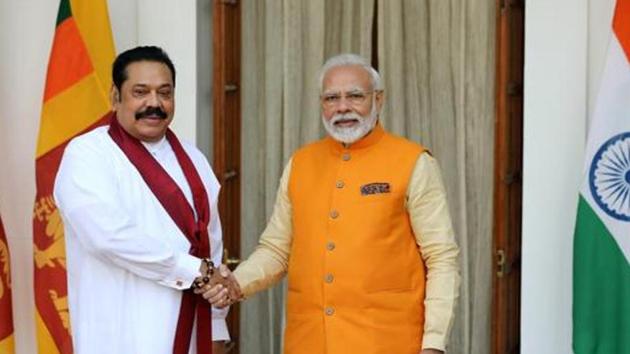 Narendra Modi, India's prime minister, right, shakes hands with Mahinda Rajapaksa, Sri Lanka's prime minister, at Hyderabad House in New Delhi.(Bloomberg file phoot)