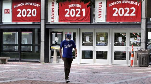 Weston Koenn, a graduate student from Los Angeles, leaves the Boston University student union building as he walks through the student-less campus in Boston.(AP)