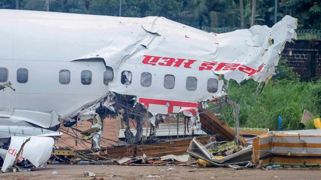 Mangled remains of an Air India Express flight, en route from Dubai, after it skidded off the runway while landing on Friday night, at Karippur in Kozhikode on August 08, 2020.(PTI Photo)