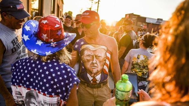 Johne Riley walks down Main Street showing off his chest painted with a portrait of President Trump during the 80th Annual Sturgis Motorcycle Rally on August 7 in Sturgis, South Dakota. Health officials meanwhile, watched with alarm at the annual 10-day motorcycle rally with fears of a superspreader event. The state has no mask mandates, and many bikers expressed defiance of measures meant to prevent contagion. (Michael Ciaglo / Getty Images / AFP)