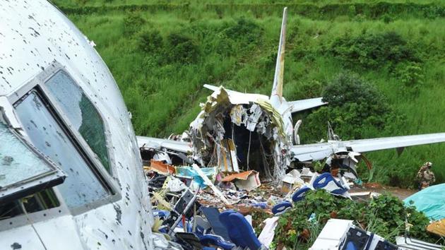 A security official inspects the site where a passenger plane crashed when it overshot the runway at the Calicut International Airport in Karipur, Kerala on August 8, 2020.(Reuters Photo)