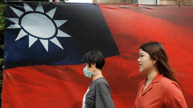 People walk past a Taiwanese flag amid the coronavirus disease (Covid-19) pandemic in Taipei, Taiwan.(Reuters Photo) People walk past a Taiwanese flag amid the coronavirus disease (Covid-19) pandemic in Taipei, Taiwan.(Reuters Photo)