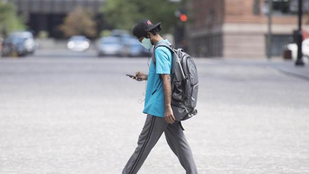 A man wears a face mask as he walks along a street in Montreal, Canada.(AP File Photo used for representational purpose only)
