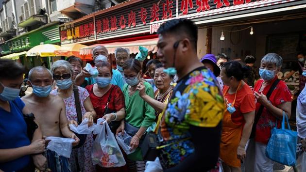 A gathering of people is seen at a market in Wuhan on August 4. The queues outside breakfast stands are a far cry from the terrified crowds that lined up at Wuhan’s hospitals in the first weeks after the city was quarantined in January to curb the spread of COVID-19 outbreak. (Hector Retamal / AFP)