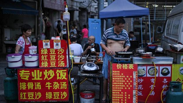 A view of a food stall in Wuhan on August 4. Food stall owner Yang Liankang (not pictured) told AFP that things are improving slowly, with sales growing from around 300 Yuan ($28.72) a day a month ago to more than 1,000 Yuan. (Hector Retamal / AFP)