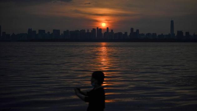 A view of Wuhan city seen from East Lake in China’s central Hubei province on August 5. China has largely brought its domestic epidemic under control, but sporadic outbreaks and a summer of severe flooding have exacerbated the economic fallout, AFP reported. (Hector Retamal / AFP)