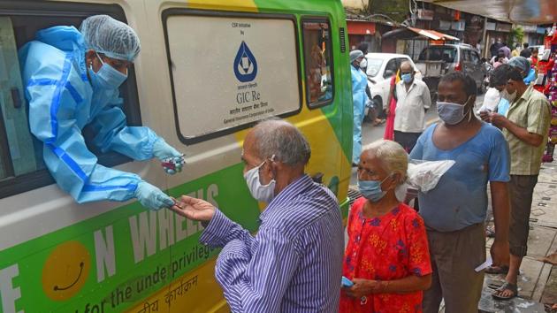 Health workers from Smile Foundation conduct thermal testing and distribute medicine in Dharavi, Mumbai on August 10. Maharashtra’s Covid-19 recovery rate on August 11 stood at 68.33%, marginally below the national average of 69.80%. A month ago on July 11, the state’s recovery rate was at 55.55%, HT reported. (Vijayanand Gupta / HT Photo)